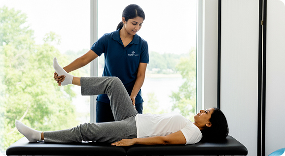 Physiotherapist assisting patient